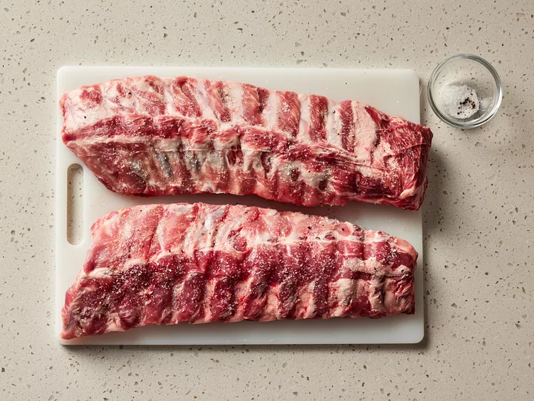 Season ribs with salt and pepper.